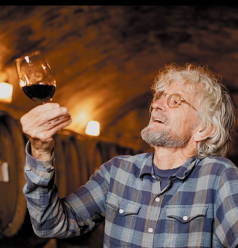Cameron Winery s owner and winemaker, John Paul, evaluating a glass of red wine. ## Photo by Fancy Baby