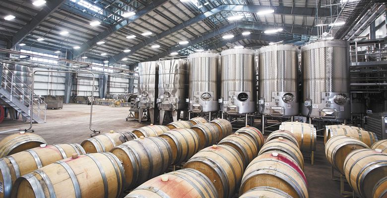 Tanks tower and barrels line the floor at the Jackson Family Wines production facility in McMinnville. ##Photo by Rockne Roll