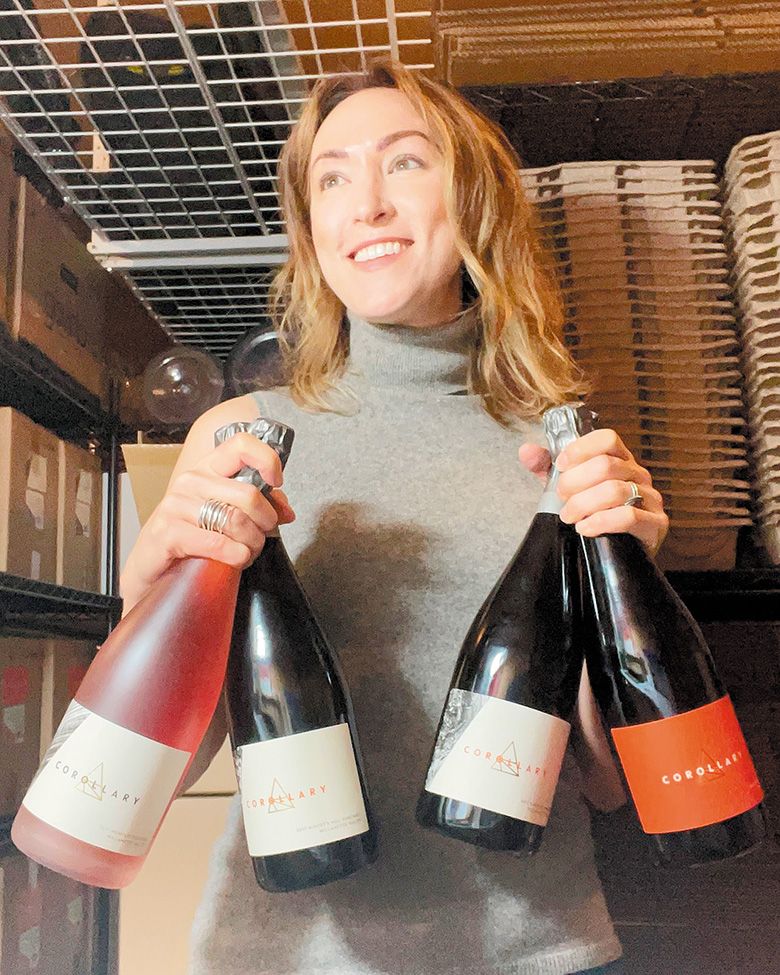 Jeanne Feldkamp, co-owner and co-winemaker for Corollary Wines, holding bottles of sparkling wine. ## Photo provided by  Corollary Wines