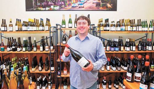 Josh Kimball selling wine in his shop in downtown Jacksonville. ##Photo provided