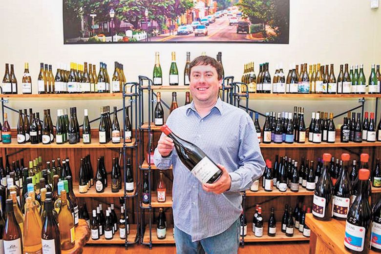 Josh Kimball selling wine in his shop in downtown Jacksonville. ##Photo provided