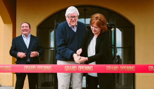 Culinary icon Emeril Lagasse watches as owners Ken and Grace Evenstad cut the ribbon of The Clubhouse at Domaine Serene, a 34,000-square-foot event facility on the winery’s estate vineyard. ##Photo Courtesy of Domaine Serene Culinary icon Emeril Lagasse watches as owners Ken and Grace Evenstad cut the ribbon of The Clubhouse at Domaine Serene, a 34,000-square-foot event facility on the winery’s estate vineyard. ##Photo Courtesy of Domaine Serene