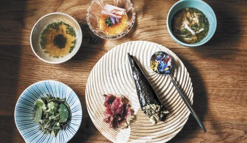 From left (top row): coastal Kombu tea; trout roe and shio koji pudding; crab custard with warm crab broth; (bottom) nasturtium leaves salad; speck; Mangaliseta ham hand roll; and honeysuckle nectar and flowers.  ##Photo by Lindsey Bolling