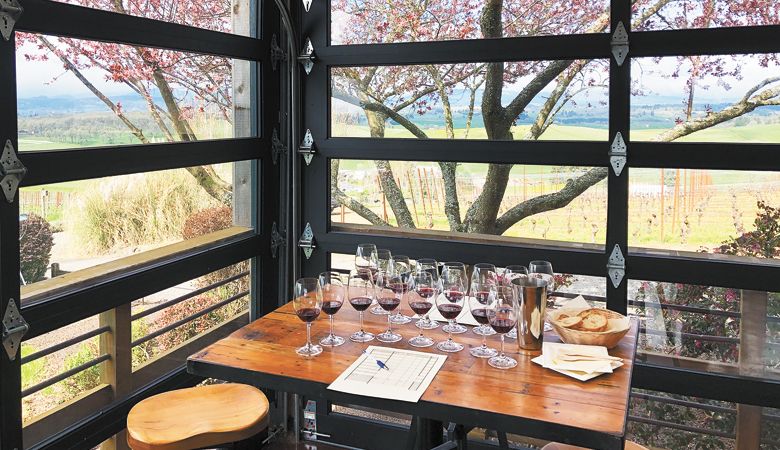 Glasses of Pinot Noir are arranged in an arc with evaluation sheets, water, a spit receptacle and palate cleansers awaiting guests at the Lenné Estate blind tasting. ##Photo by Annelise Kelly