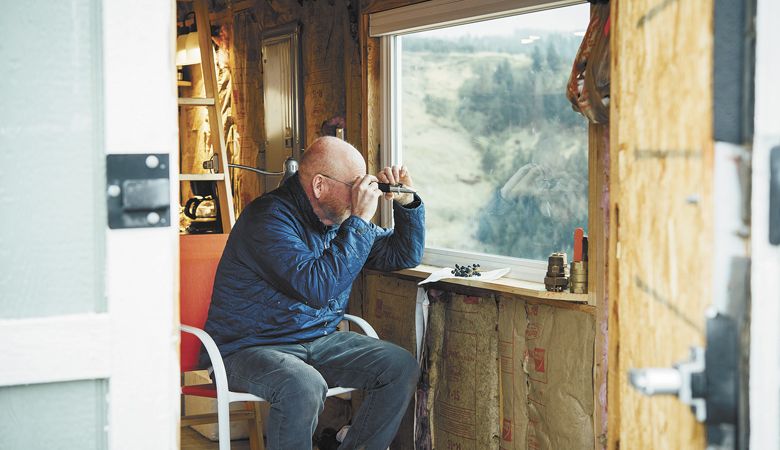 Winegrower Dean Richards checks for sugar levels in his refractometer. He has cultivated a test site called the Lewis Peak Experimental Vineyard in the Blue Mountains. ##Photo by Kathryn Elsesser