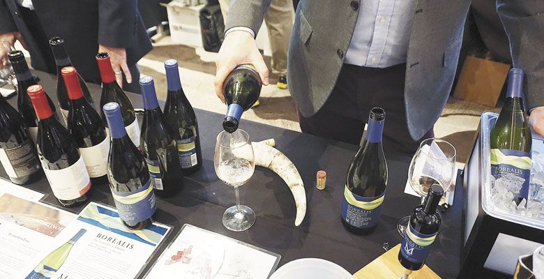 A Montinore Estate representative samples wines at the Dallas tasting with a cow horn on the table to help illustrate the winery’s Biodynamic farming practices. ##Photo by Dan Eierdam