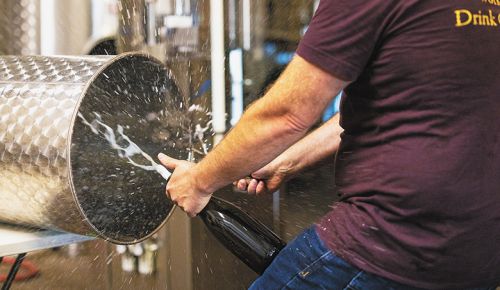 Michael Lundeen, owner and winemaker of Lundeen Wines, disgorging a bottle of sparkling wine. ## Photo provided by Lundeen Wines