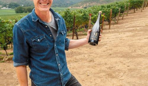 Jean-Michel Jussiaume, Maison Jussiaume s owner and winemaker, holds a bottle of his sparkling wine in the Del Rio Vineyard. ## Photo provided by Maison Jussiaume