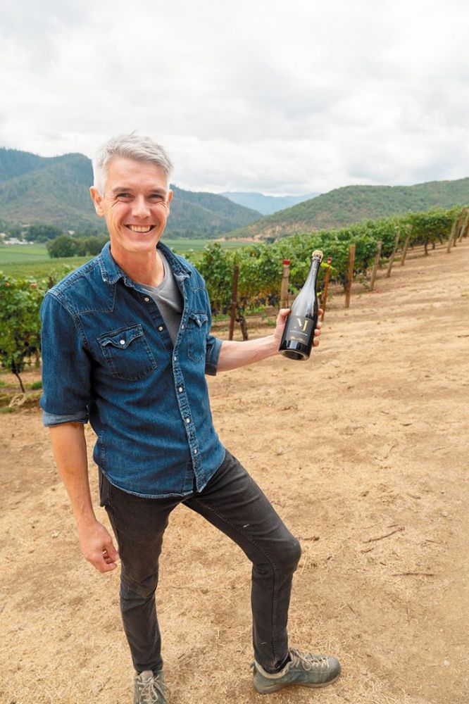 Jean-Michel Jussiaume, Maison Jussiaume s owner and winemaker, holds a bottle of his sparkling wine in the Del Rio Vineyard. ## Photo provided by Maison Jussiaume