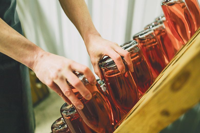 Winemaker Jean-Michel Jussiaume riddling bottles of his Maison Jussiaume sparkling ros&eacute;. ## Photo provided by Method Oregon