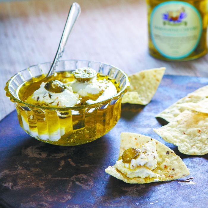 Fresh goat cheese marinated in olive oil and jalapenos. Fresh goat cheese marinated in olive oil and jalapenos.