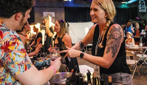 An attendee at the heavy metal-themed festival Blood of Gods Annual Merrymaking receiving a wine sample. ## Photo provided by Blood of Gods