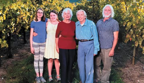 From left: Grandchildren Anya and Savonne stand with grandparents Traute and Don Moore and father Michael.##Photo provided