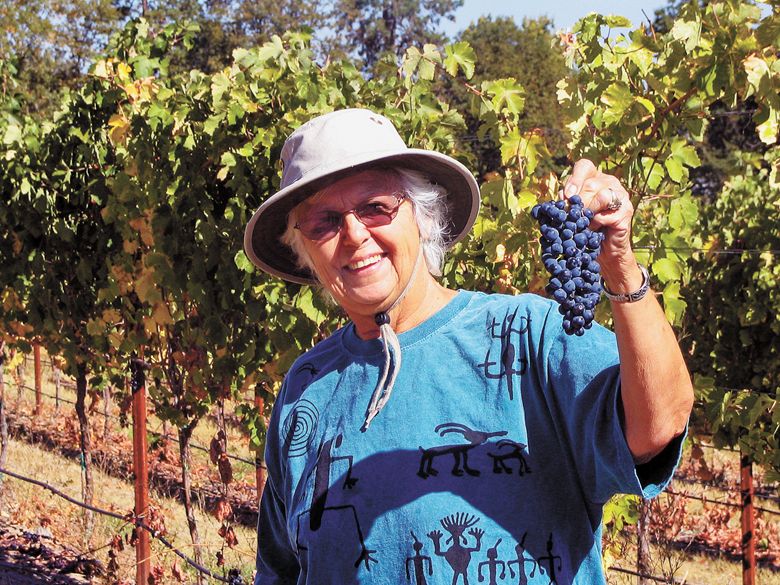 Traute Moore, in the vineyard, sharing the fruits of her labor.##Photo provided