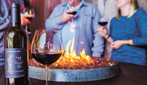 Visitors stay toasty around a fire pit at Pete’s Mountain Vineyard & Winery in West Linn.##Photo provided