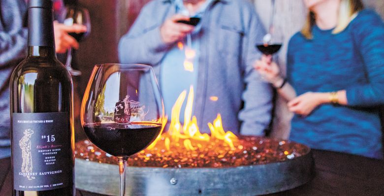 Visitors stay toasty around a fire pit at Pete’s Mountain Vineyard & Winery in West Linn.##Photo provided