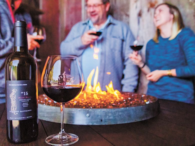 Visitors stay toasty around a fire pit at Pete’s Mountain Vineyard & Winery in West Linn.##Photo provided