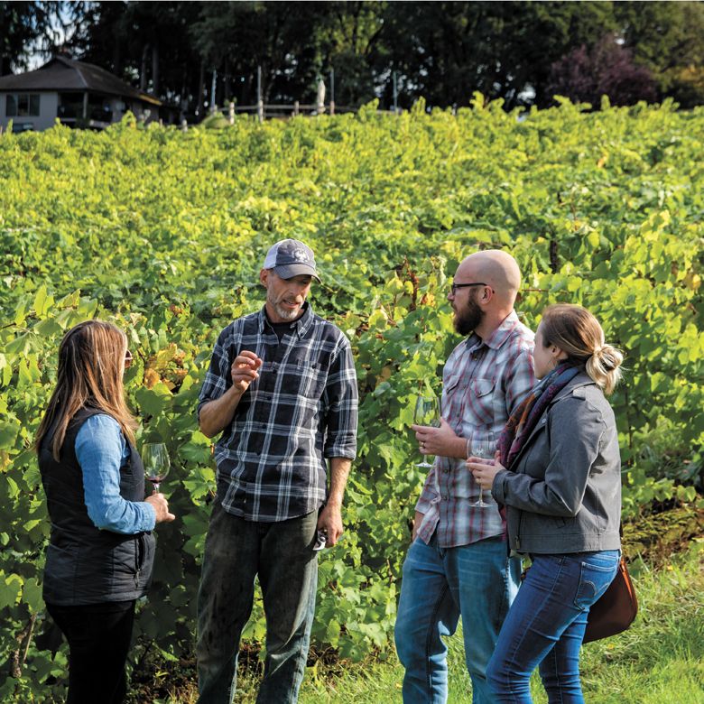 Guests at Oregon City’s King’s Raven Winery enjoying wine among the vines.##Photo provided
