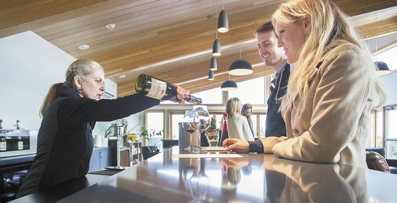 Diane Shimshak pours a sample of wine at the sleek, new bar. ##Photos by Rockne Roll