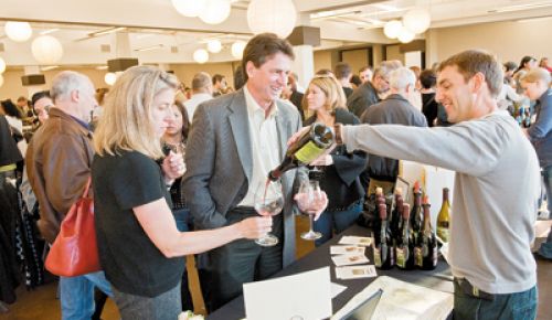 Todd Hansen of Longplay Wines pours a bottle of Pinot Noir at last year s Chehalem Mountains Winegrowers Portland tasting.  Photo by Andrea Johnson.