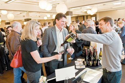 Todd Hansen of Longplay Wines pours a bottle of Pinot Noir at last year s Chehalem Mountains Winegrowers Portland tasting.  Photo by Andrea Johnson.