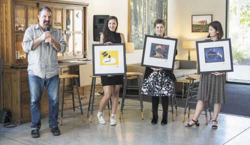 Chris Cullina, Argyle director of sales and marketing, presents the winning artists (from left), Lindsey Walker, Christin Engelberth and Subin Yang, all students at Pacific Northwest College of Art, and their art during the official launching of “The Art of Sparkling.”
##Photo by Greg Kozawa for Argyle Winery