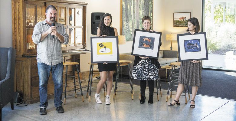 Chris Cullina, Argyle director of sales and marketing, presents the winning artists (from left), Lindsey Walker, Christin Engelberth and Subin Yang, all students at Pacific Northwest College of Art, and their art during the official launching of “The Art of Sparkling.”
##Photo by Greg Kozawa for Argyle Winery