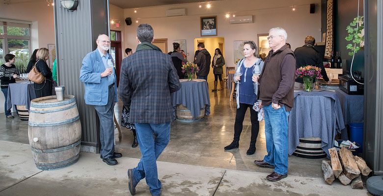 Scott Shull speaks with guests during the dinner at Raptor Ridge. ##Photo by Andrea Johnson