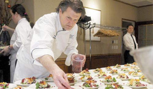 Chef Cory Schreiber prepares one of the many dishes presented to guests at the Oregon Dungeness Crab Commission dinner. Photo by Rick Schafer.