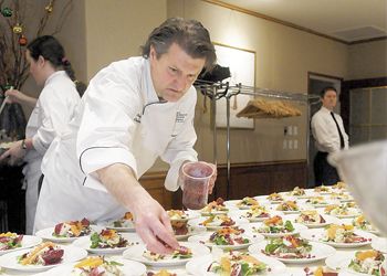 Chef Cory Schreiber prepares one of the many dishes presented to guests at the Oregon Dungeness Crab Commission dinner. Photo by Rick Schafer.