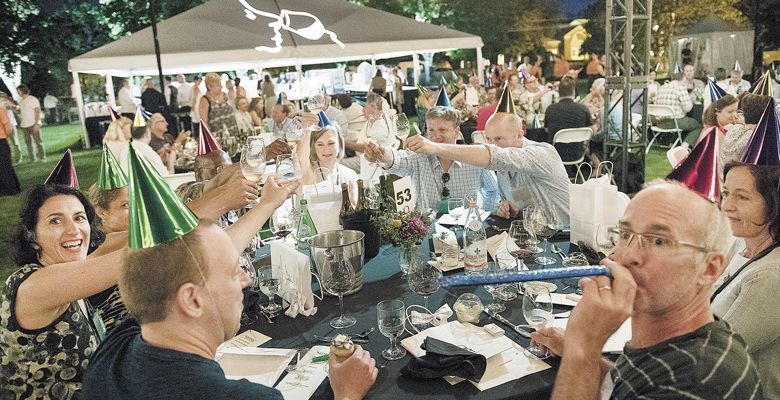 IPNC guests celebrate the event’s 30th with noisemakers, hats and more provided by organizers. ##Photo by Andrea Johnson