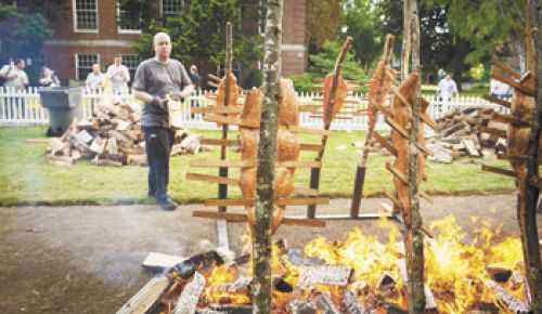 Jason Stoller Smith performs his yearly duty of preparing salmon for guests at IPNC s Salmon Bake on the campus at Linfield College.