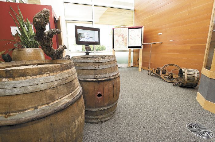 French oak aging barrels and an antique wine press are part of Linfield’s Oregon wine
history exhibit, “Bringing Vines to the Valley.” Photo by Marcus Larson.