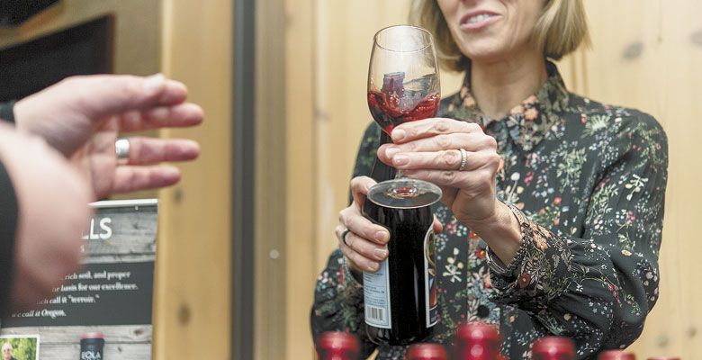 Elaine Cuyler offers a taste of Eola Hills Wine Cellars’ Beaujolais-style wine during last year’s Beaujolais Nouveau Festival at The Heathman in downtown Portland. ##Photo by Aubrie LeGault
