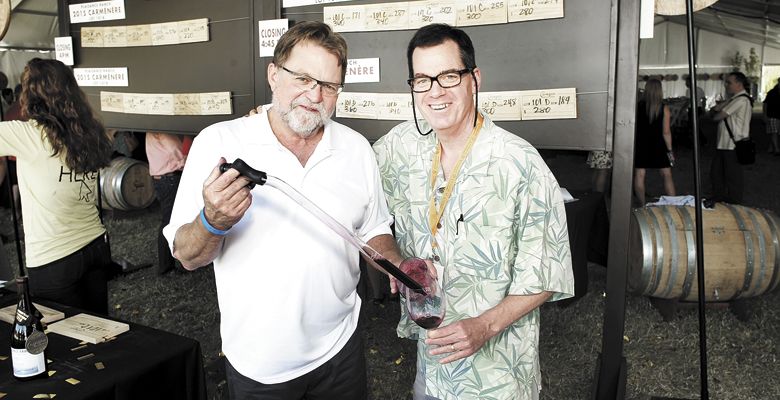 Joe Ginet of Plaisance Ranch pulls a barrel sample for Whitman Parker, editor of The Jacksonville Review and Southern Oregon Wine Scene. ##Photo by Steven Addington Photography