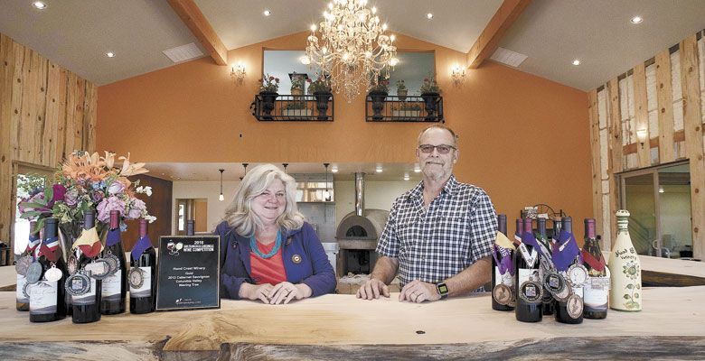 Patrik and Tess Barr stand behind the bar made from timber gathered from their Hood River property. ##Photo provided by Hood Crest