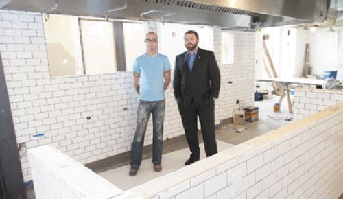 Paulée owners, Executive Chef daniel Mondok (left) and Sommelier Brandon tebbe, stand in what will be dundee’s newest upscale restaurant, set to open in May.