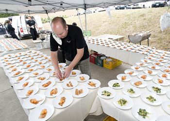 Jason Stoller Smith,
formerly of the Dundee Bistro, prepares food for
the event. Photo by Marcus Larson.