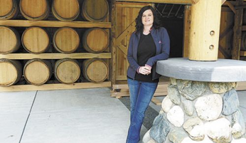 Rachael Martin stands in front of the new Red Lily Vineyards Tasting Room in Jacksonville. Photo provided.