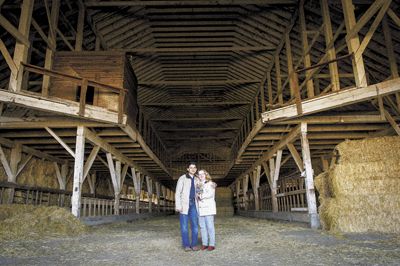 Sanjeev Lahoti and Angela Summers stand inside the huge dairy barn, which has now been dismantled for reuse in their new tasting room. Sanjeev Lahoti and Angela Summers stand inside the huge dairy barn, which has now been dismantled for reuse in their new tasting room.
