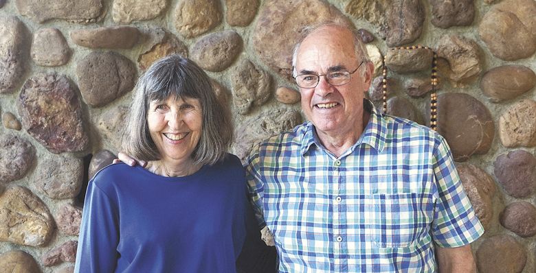 Linc and Joan Wolverton stand in front of their fireplace made with rocks sourced while plowing for their vineyard in 1971. ##Photo by Viki Eierdam