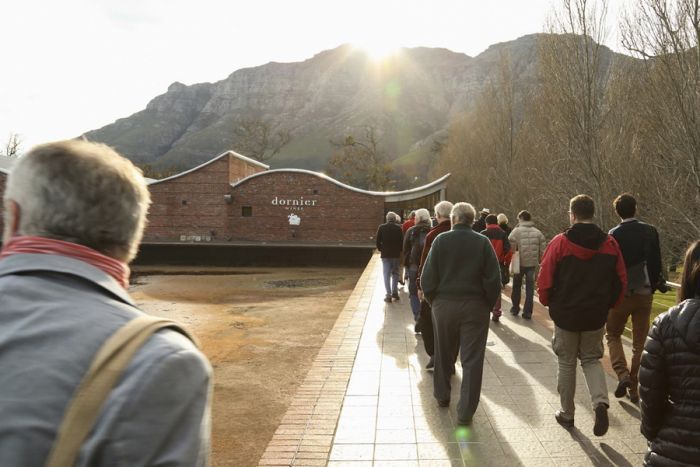 On a winery tour, AAWE members approach Dornier Winery in Stellenbosch, South Africa, on a winter day in June. Photo by Truburn Photography. On a winery tour, AAWE members approach Dornier Winery in Stellenbosch, South Africa, on a winter day in June. Photo by Truburn Photography.
