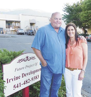 Doug and Dionne Irvine stand in a parking lot that will soon be transformed into a multi-use building called The Vine; it will house a tasting room, boutique inn and more.