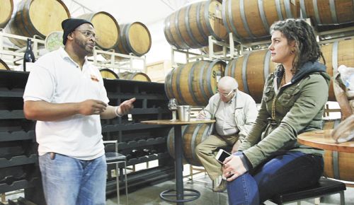 Marcus Horne, owner of Homegrown Weed & Wine Tours, chats with a participant at Duck Pond Cellars in Dundee. ##Photo by Nick Taylor