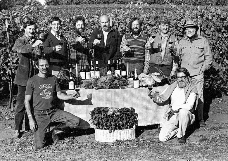 The founding members of the Yamhill County Wineries Association raise their glasses in a toast for a publicity photograph for the first “Thanksgiving Weekend in Wine Country.” Front row (kneeling, left to right): Joe Campbell of Elk Cove Winery, David Adelsheim of Adelsheim Vineyard. Back row, (standing, left to right): Bill Blosser of Sokol Blosser Winery, Don Byard of Hidden Springs, Myron Redford of Amity Vineyards, Dick Erath of Erath Vineyards, Fred Arterberry of Arterberry Winery, Fred Benoit of Chateau Benoit, David Lett of The Eyrie Vineyards. ##Photo courtesy of Sokol Blosser Winery and Susan Sokol Blosser