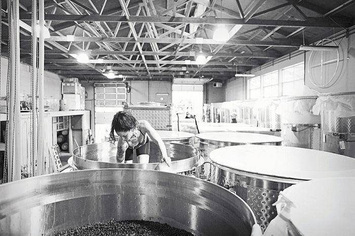 Sarah Cabot climbs into a tank while making Omero Pinot Noir. Sarah Cabot climbs into a tank while making Omero Pinot Noir.