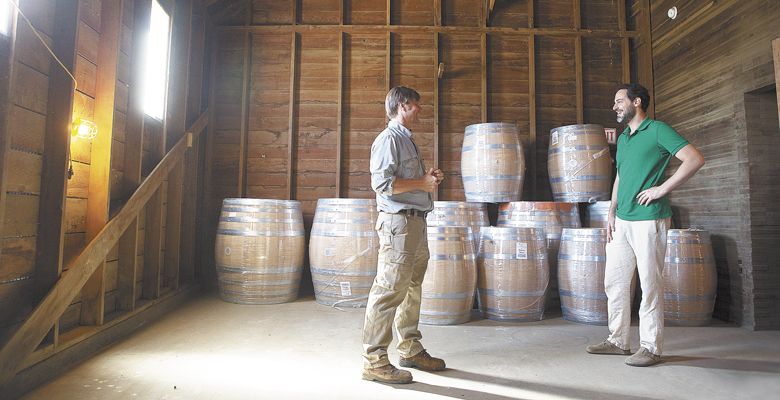 Flaneur owner Martin Doerschlag talks with hospitality manager Russell Lichtenthal inside the Madsen Grain Elevator. Doerschlag is renovating it into a future tasting room and event center. ##Photo by Rockne Roll