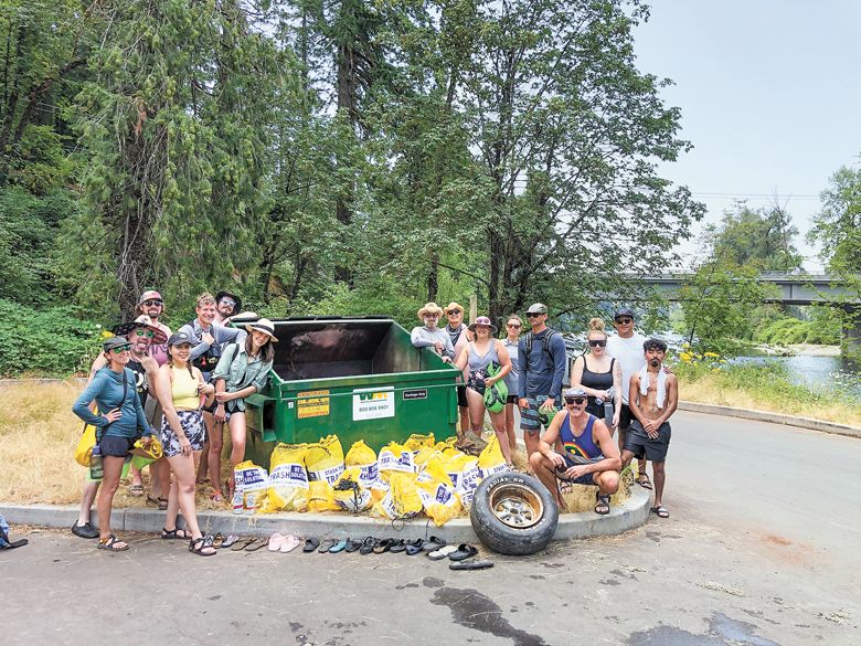 Company employees enjoy getting paid to clean up a stretch of the Clackamas River. Pictured with all the garbage collected that day.##Photo PROVIDED
