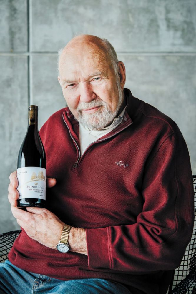 Dick Erath holds a bottle of his Grand Vin de Garage 2016 Prince Hill Pinot Noir Clone 95, a retirement project that caps  a 50-plus-year career in wine. ##Photo by Kathryn Elsesser