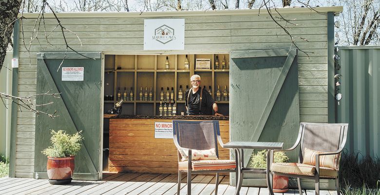 Marble Caves Distillery owner Rod Warner stands inside his charming tiny tasting room perfect size for sampling his small-batch distilled rum, as well as apple and pear brandies. ##Photo by Kathryn Elsesser